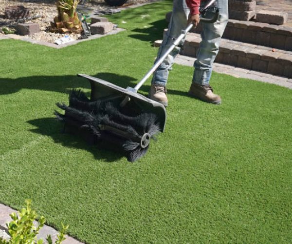 shot of worker doing fake grass