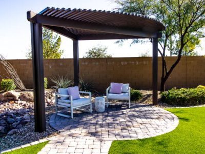Small Back Yard Pergola With Two Sitting Chairs On Round Pavers Patio