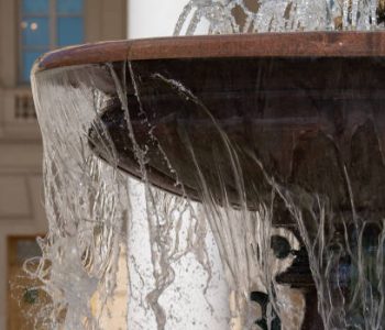 city fountain with granite bowl on a bright sunny day